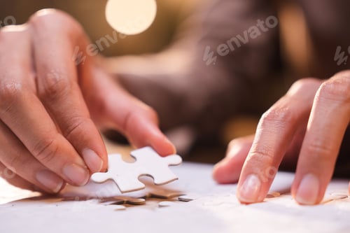 Preview: Business person team work holding jigsaw to connecting successful puzzle piece