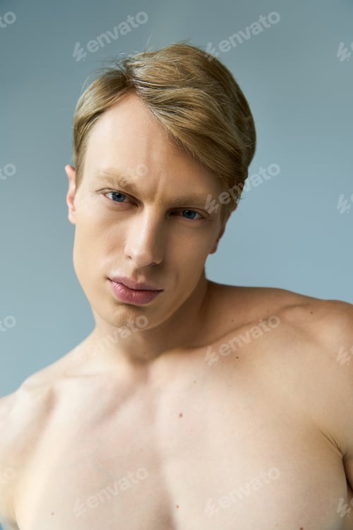 Preview: Modern masculinity shines through a young mans captivating gaze in a serene setting