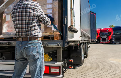 Preview: Worker Loads Boxes Onto a Truck at a Shipping Yard