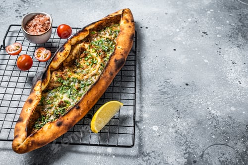 Preview: Turkish pide, traditional pie with beef meat and vegetables. White background. Top view. Copy space