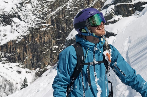 Preview: Male skier looking up mountainside, Alpe-d'Huez, Rhone-Alpes, France