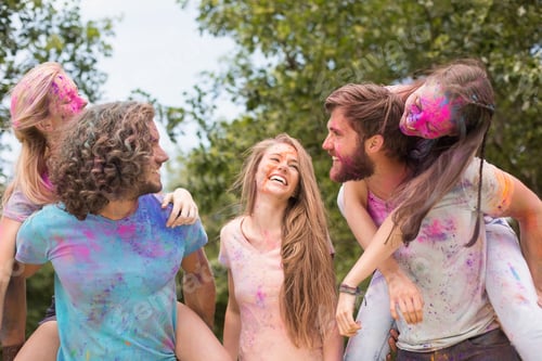Preview: Happy friends covered in powder paint on a sunny day
