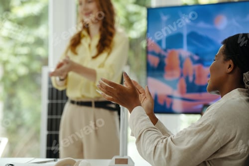 Preview: Woman Applauding To Colleague At Presentation