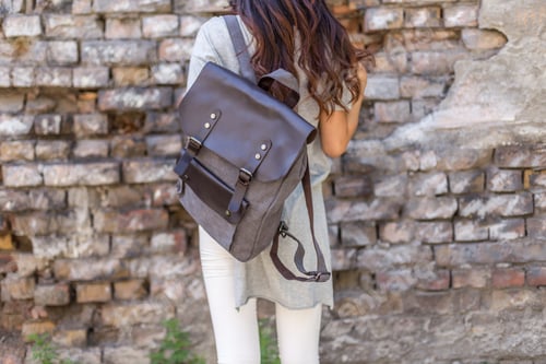 Preview: Back of woman with gray canvas backpack