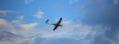Preview: Small plane on blue sky background