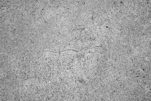 Preview: Rough gray concrete texture background with natural grain pattern and subtle surface cracks