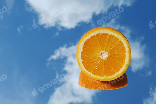 Preview: Orange citrus fruit tropical orange on blue sky and clouds background.