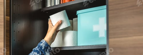 Preview: Close up of woman hand organizing emergency food pantry. Alert, foresight and self sufficiency.