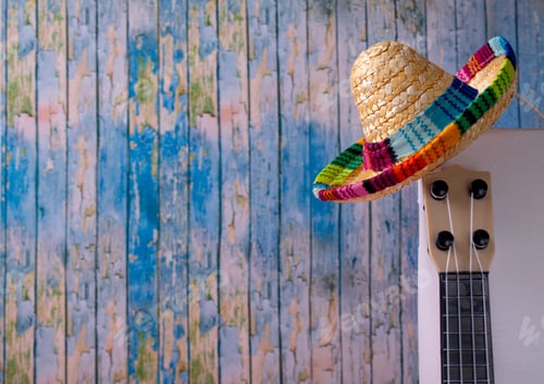 Preview: Mexican composition with copy space. Guitar and sombrero hat on blue background.