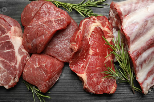 Preview: Flat lay composition with fresh meat on black wooden table