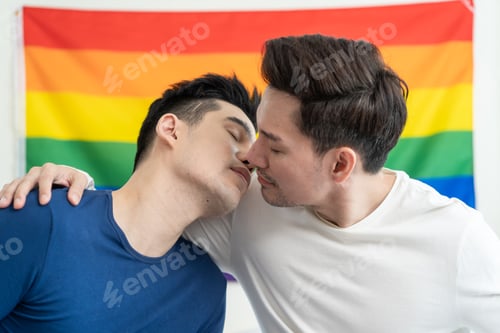 Preview: Portrait of Asian handsome man gay family holding LGBT flag and smile.
