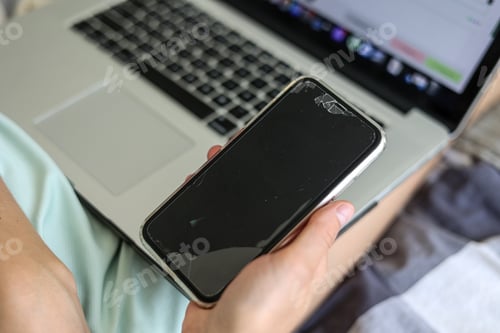 Preview: Unrecognisable woman is using, texting, messaging smartphone with a broken touch screen, glass wi