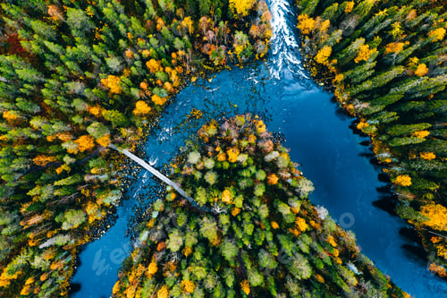 Preview: Aerial view of fast river flow through the rocks and colorful forest. Autumn in Finland