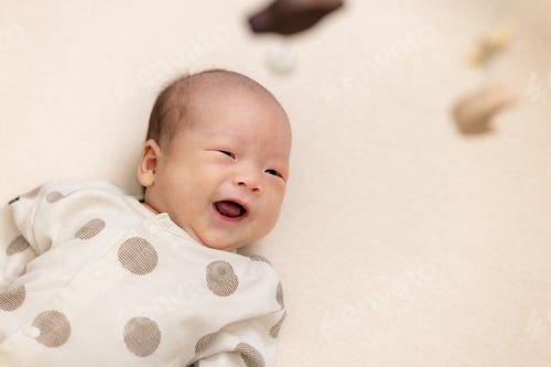 Preview: Adorable smile baby lying on the baby cot