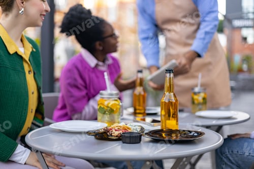 Preview: Friends Dining Outdoors at Cafe