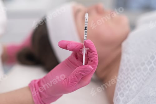 Preview: Professional beautician holding syringe to smoothing wrinkles with injections. mesotherapy