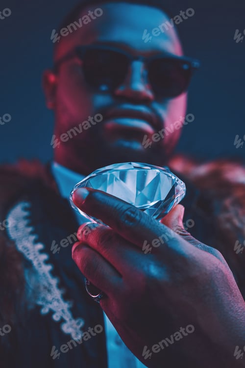 Preview: Rich african man with fur holding luxurious diamond
