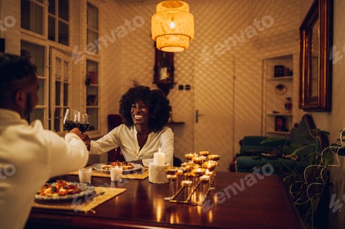 Preview: Portrait of an african american woman having a romantic date at home with her boyfriend
