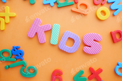 Preview: colorful plastic letters on orange background, Top view