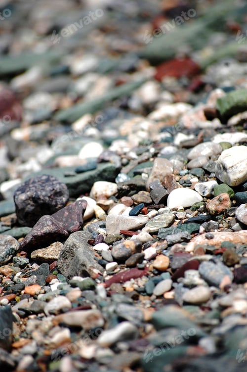 Preview: Vertical closeup of a rocky landscape featuring small stones scattered throughout