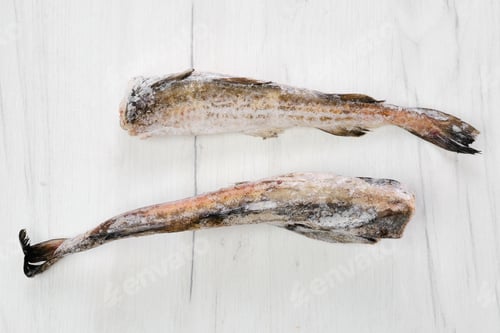 Preview: Frozen pollock carcass on wooden table