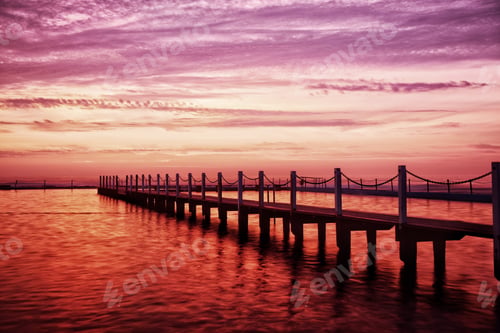Preview: A beautiful moment at dawn. The sky and water bathed in the early morning glow of pinks and oranges
