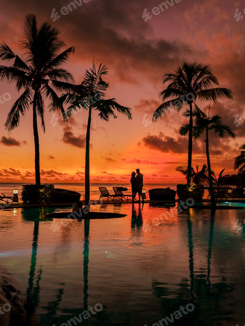 Preview: Man and Woman relaxing in a swimming pool, a couple on a honeymoon vacation in Mauritius