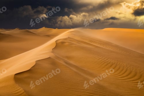 Preview: Sunset over the sand dunes in the desert. Arid landscape of the Sahara desert.