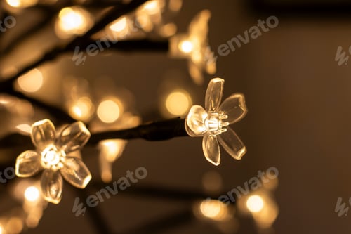 Preview: Illuminated flower string lights with bokeh effect.