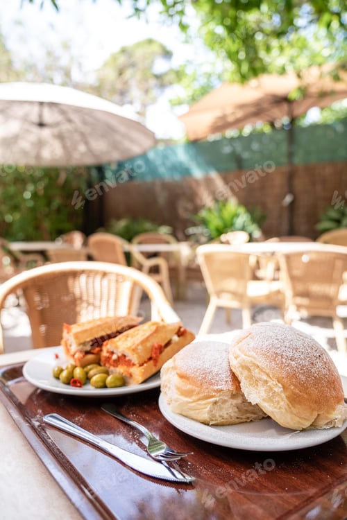Preview: Iberian sobrasada sandwich served with olives on the terrace of a restaurant