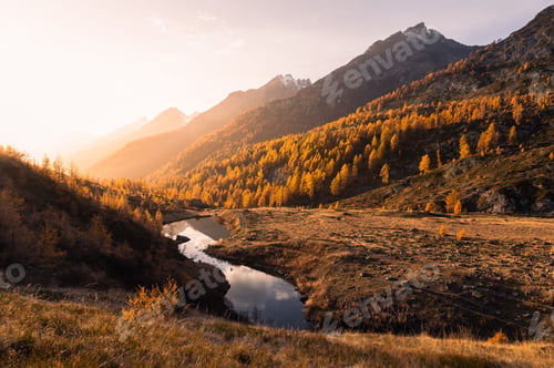 Preview: Landscape view of an autumn sunset over the Grundsee mountain lake surrounded by golden larches