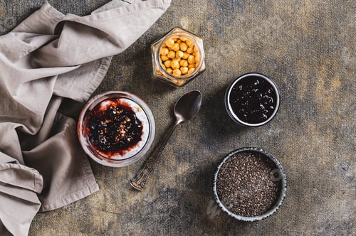 Vista previa: Chia pudding with yogurt and blackcurrant jam in a glass on the table top view