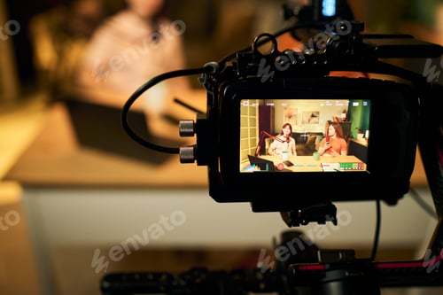 Preview: Two Teenager Girls Recording Podcast with Microphones in Studio Setting