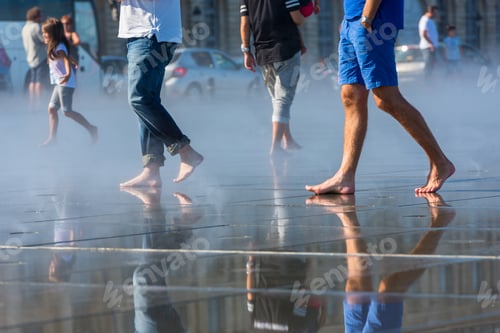 Preview: People having fun in a mirror fountain in Bordeaux, France
