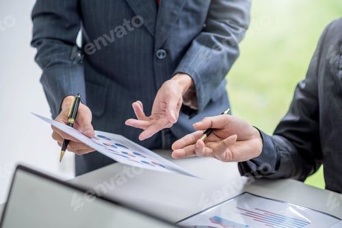 Preview: Business people meeting analyzing financial documents at meeting.