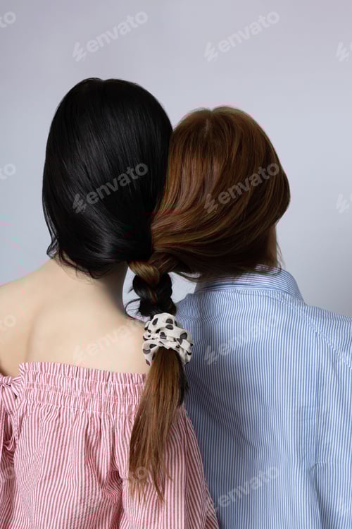 Preview: Two Women in Stylish Shirts With Braided Hair