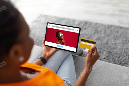 Preview: Millennial african american woman using tablet and credit card, buying fashion clothes in internet