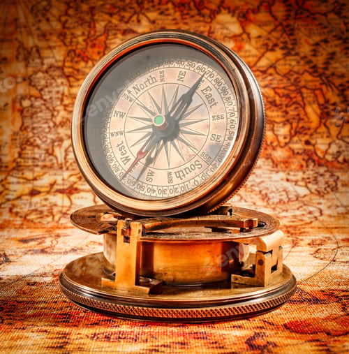 Preview: Vintage compass lies on an ancient world map.