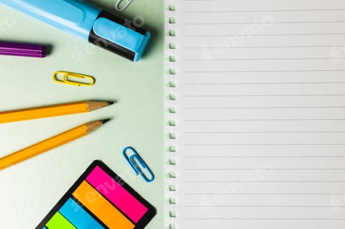 Preview: Composition of notebook with copy space and school tools on green surface