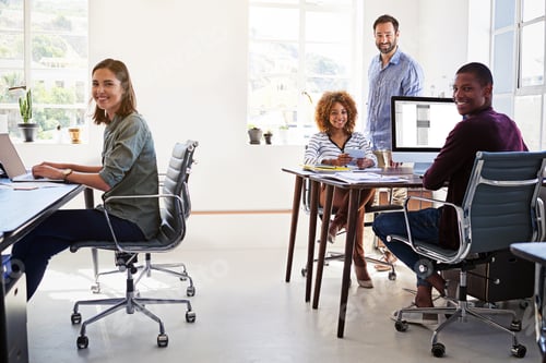 Preview: Portrait of a team of colleagues working in an open plan office