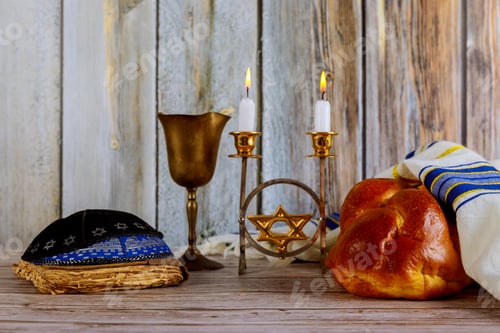 Preview: Shabbat Jewish holiday with challah bread on a candles and cup of wine.
