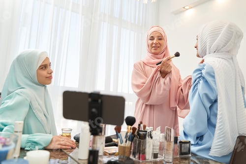 Preview: Confident Muslim woman working on makeup online