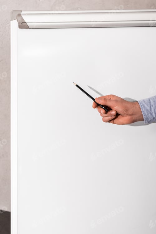 Preview: cropped image of businessman showing something at flipchart