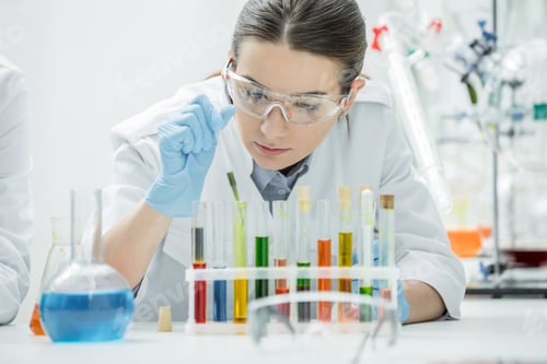 Preview: Female scientist working with chemical samples in test tubes in laboratory