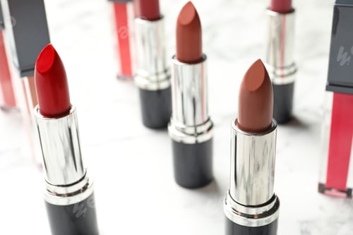 Preview: Different lipsticks on light background. Cosmetic product