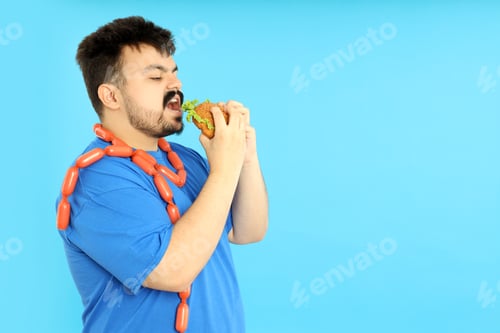 Preview: Concept of weight problems, young fat man on blue background