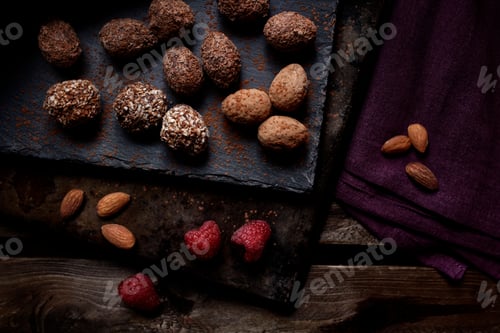 Preview: Top view of chocolate truffles with raspberries and almonds