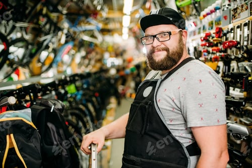 Preview: Bicycle mechanic with wheel in bike shop