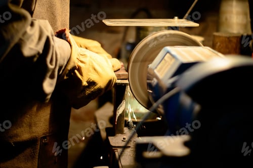 Preview: Hands of a worker wearing gloves and welding in the factory