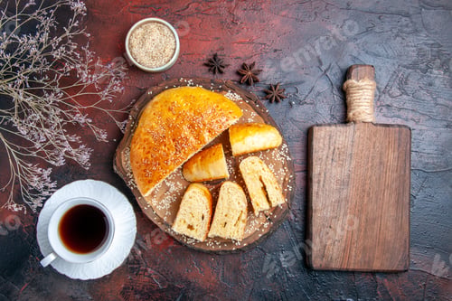 Preview: top view tasty sweet pastry sliced in pieces with tea on dark background dough cake pie